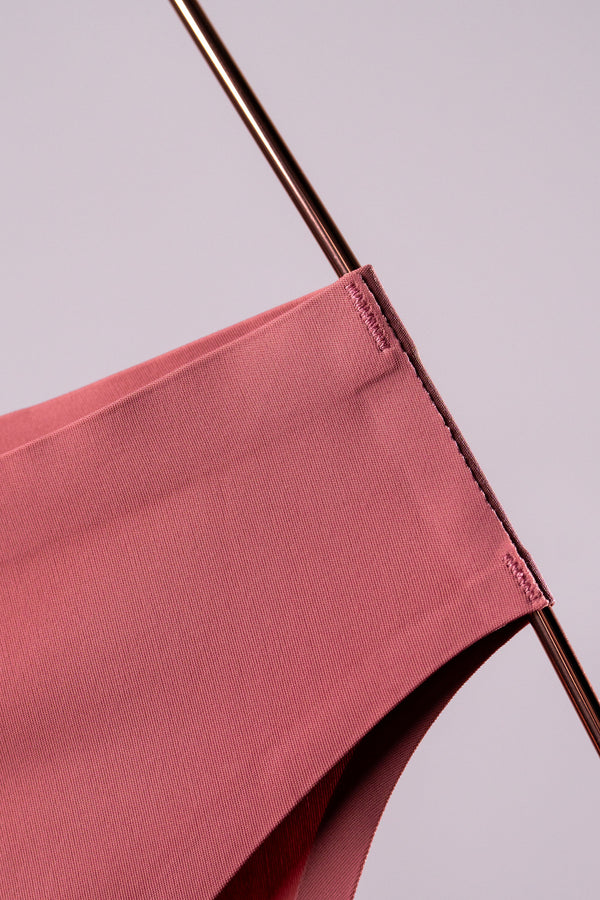 Dusty pink brief on a copper hanger