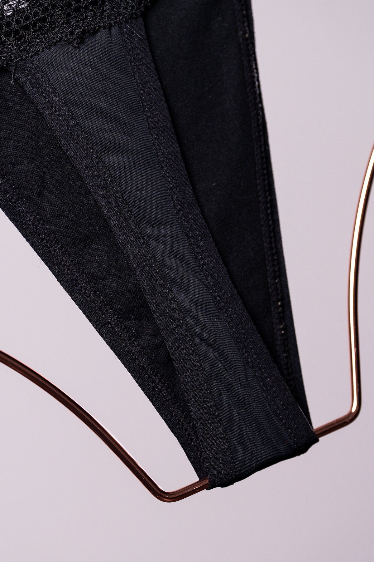 Black leak-proof underwear on a copper hanger