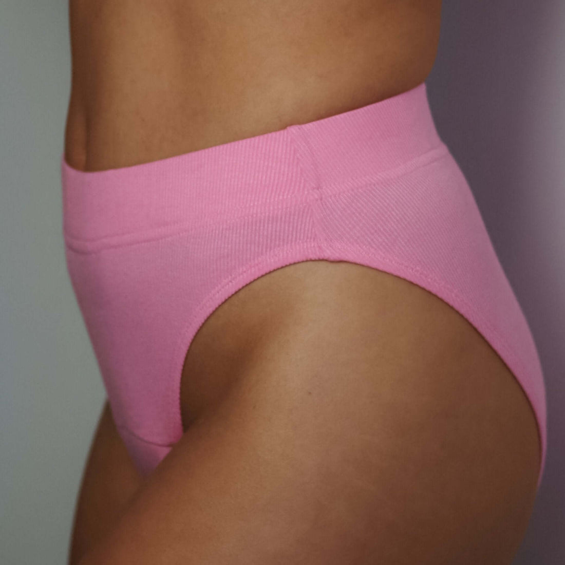 Pink high-leg period underwear providing comfort and eco-friendly protection with a flattering fit.