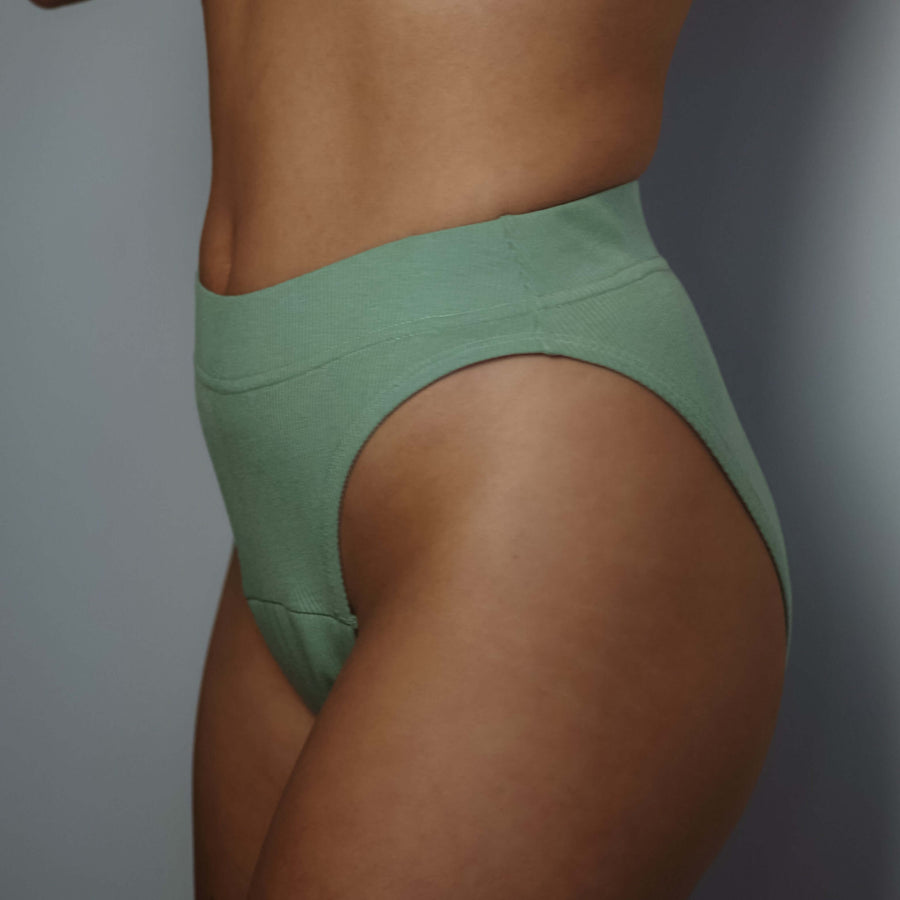 Woman wearing Simplechicks' green period underwear with high-leg design showcasing comfort and eco-friendly materials.